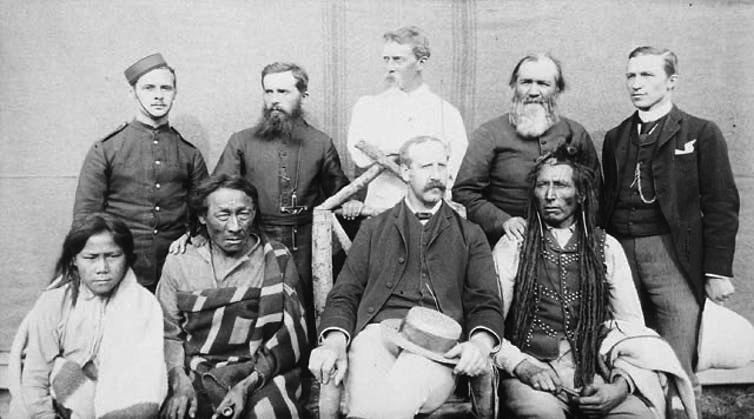 Photograph of Poundmaker, Big Bear, Big Bear’s son, Father Andre, Father Conchin, Chief Stewart, Capt. Deane, Mr. Robertson, and the Court Interpreter.